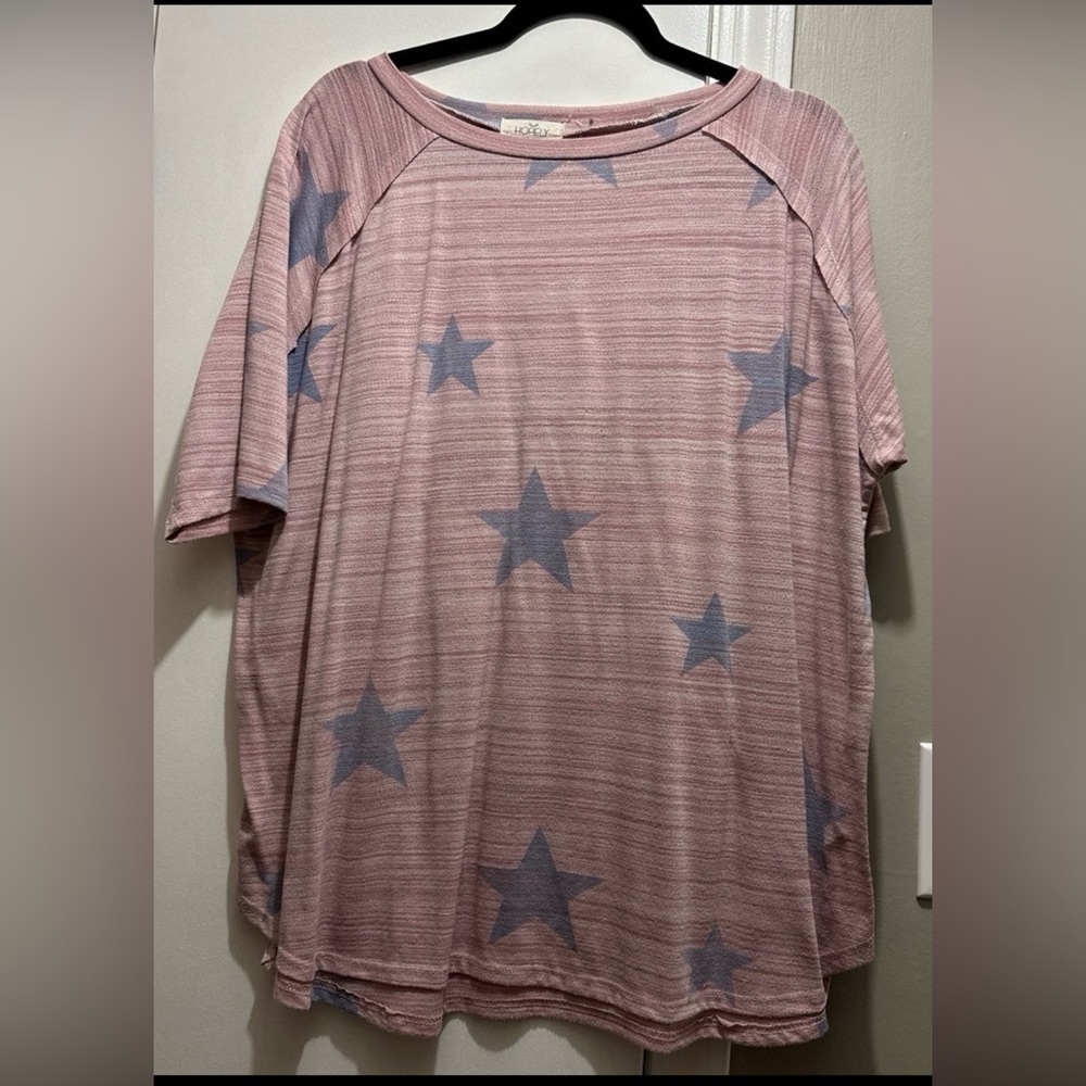 Short sleeve women’s shirt. Light red with blue stars.